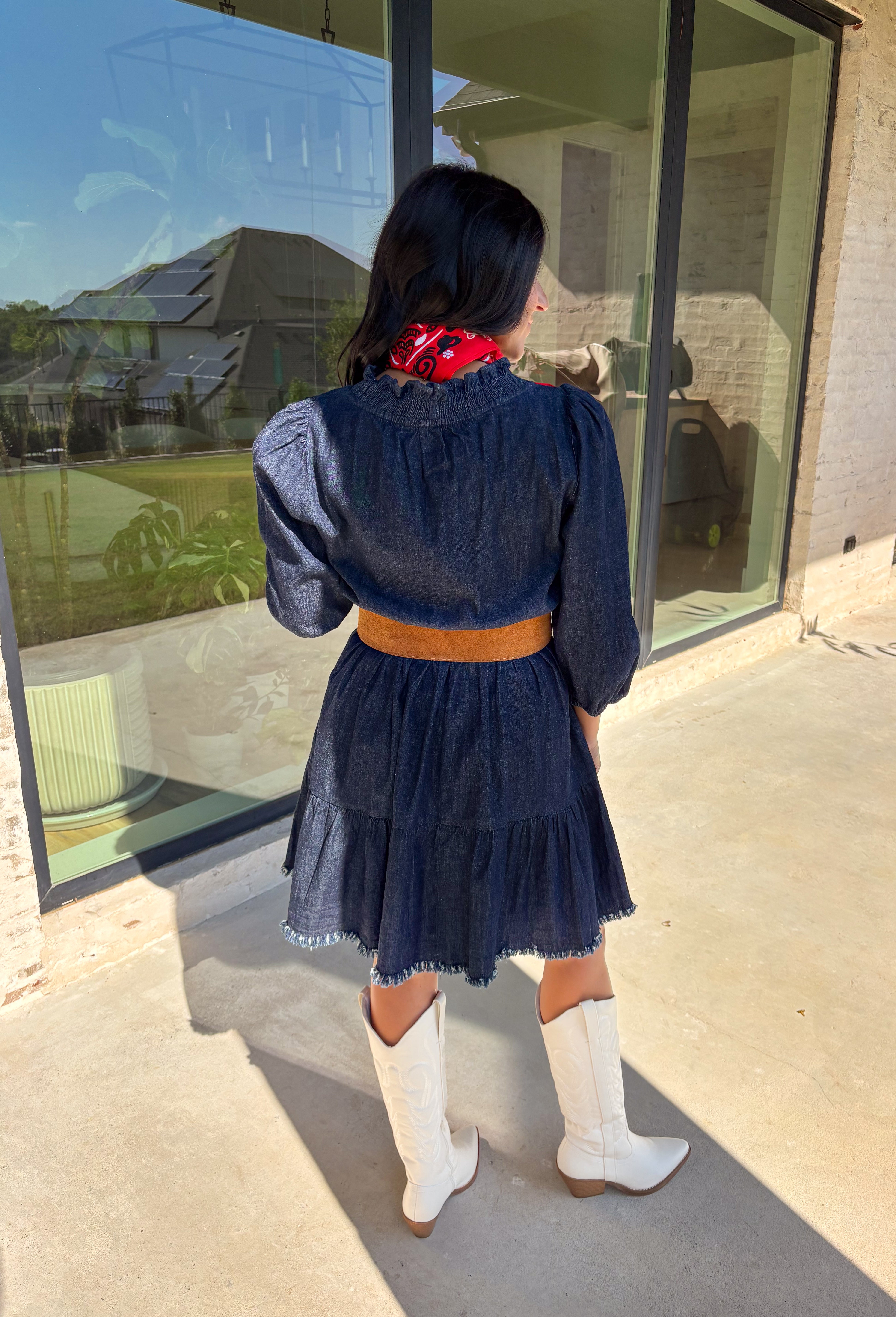 Denim with a feminine twist—this long sleeve dress is a seasonal must-have. Designed in a rich dark wash, it features a flattering smocked waist and a raw edge hem that adds a casual, lived-in feel. The ruffle trim softens the look, while elastic cuff sleeves keep it comfortable and easy to wear. Made from a cotton blend, it’s lightweight enough to layer and cozy enough to wear on its own for crisp fall days.