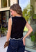 Timeless, polished, and endlessly versatile, this sweater tank from Day + Moon is a piece you'll reach for season after season. Designed in a classic black knit, it features beautiful ivory contrast trim along the neckline and arm openings for a refined touch. The ivory scalloped hem adds the perfect feminine finish, making this sleeveless sweater just as pretty worn on its own as it is layered under jackets and cardigans.