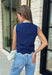 Classic with a touch of charm, this navy sweater tank is made for the season ahead. The rich autumn hue is beautifully accented with crisp white trim and a delicate scalloped hem, creating a timeless look that's both polished and playful. Crafted from a soft sweater knit, it's perfect for layering under your favorite blazer, denim jacket, or cardigan as the temperatures begin to cool. 