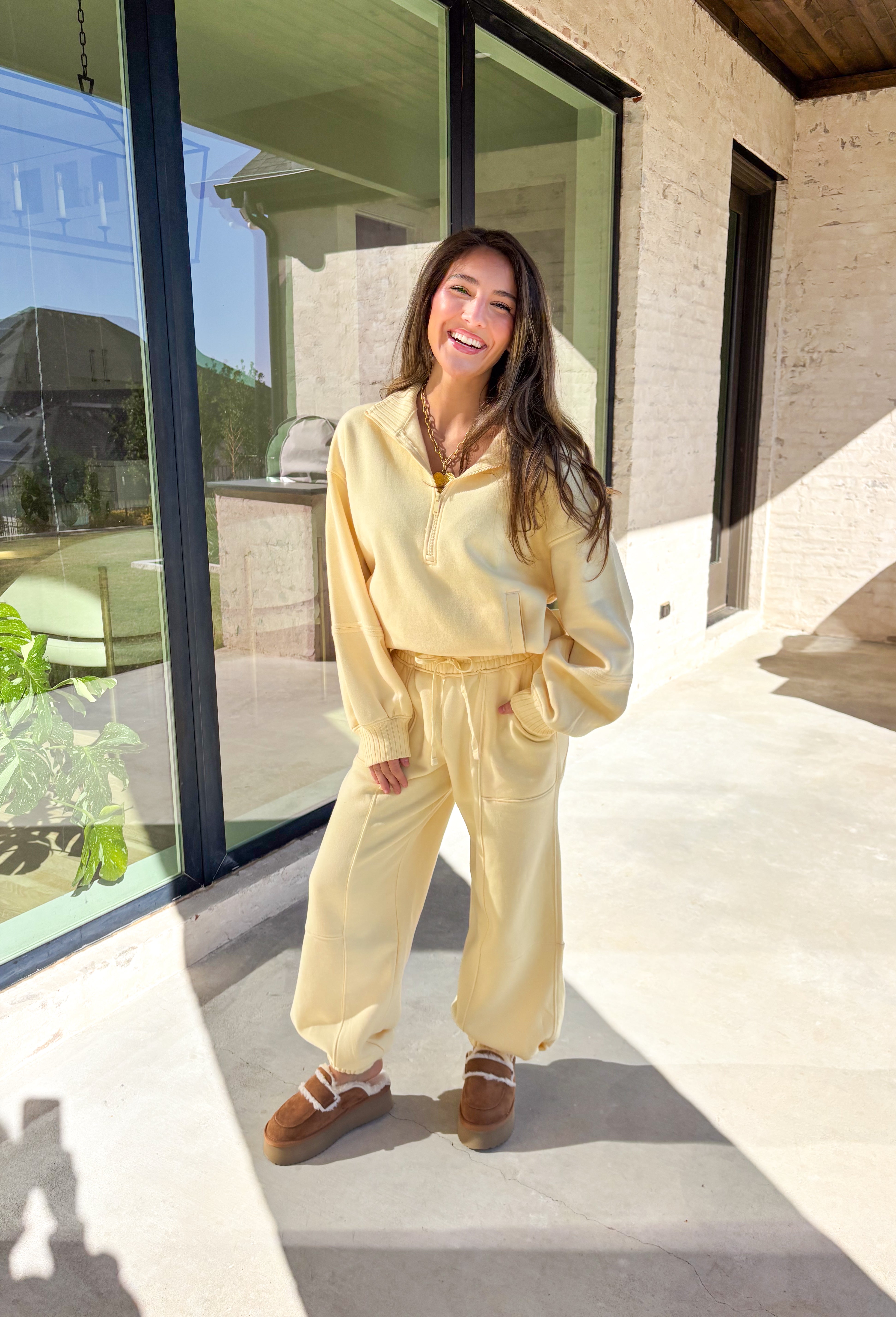 Stay cozy in style with these butter yellow barrel joggers by Rae Mode. Lined in soft fleece and finished with a drawstring elastic waistband, these joggers offer the perfect blend of comfort and warmth for chilly winter days. Featuring side and back pockets for everyday convenience, their relaxed barrel silhouette makes them ideal for lounging or layering on the go. Pair them with the matching quarter-zip pullover for a complete cozy set or wear them solo for a laid-back, stylish look.