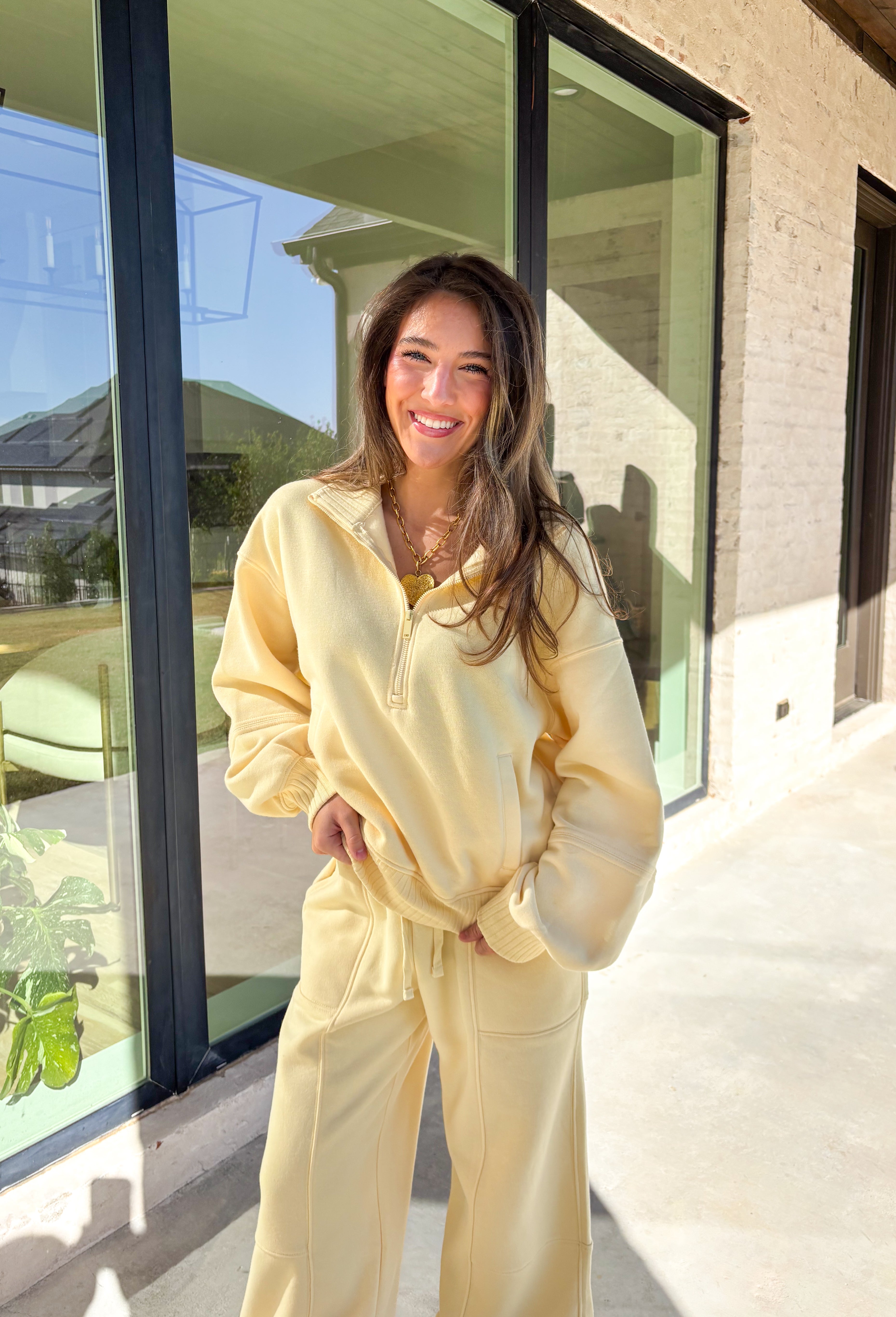 Cozy up this winter in the butter yellow fleece quarter zip pullover by Rae Mode. Designed with ribbed detailing along the collar, hem, and sleeve cuffs, this pullover combines a relaxed fit with an effortlessly polished look. The soft fleece interior and front pockets add extra warmth and comfort, making it the perfect throw-on for chilly days. Pair it with the matching joggers for the full set, or style it solo for an easy, laid-back outfit.