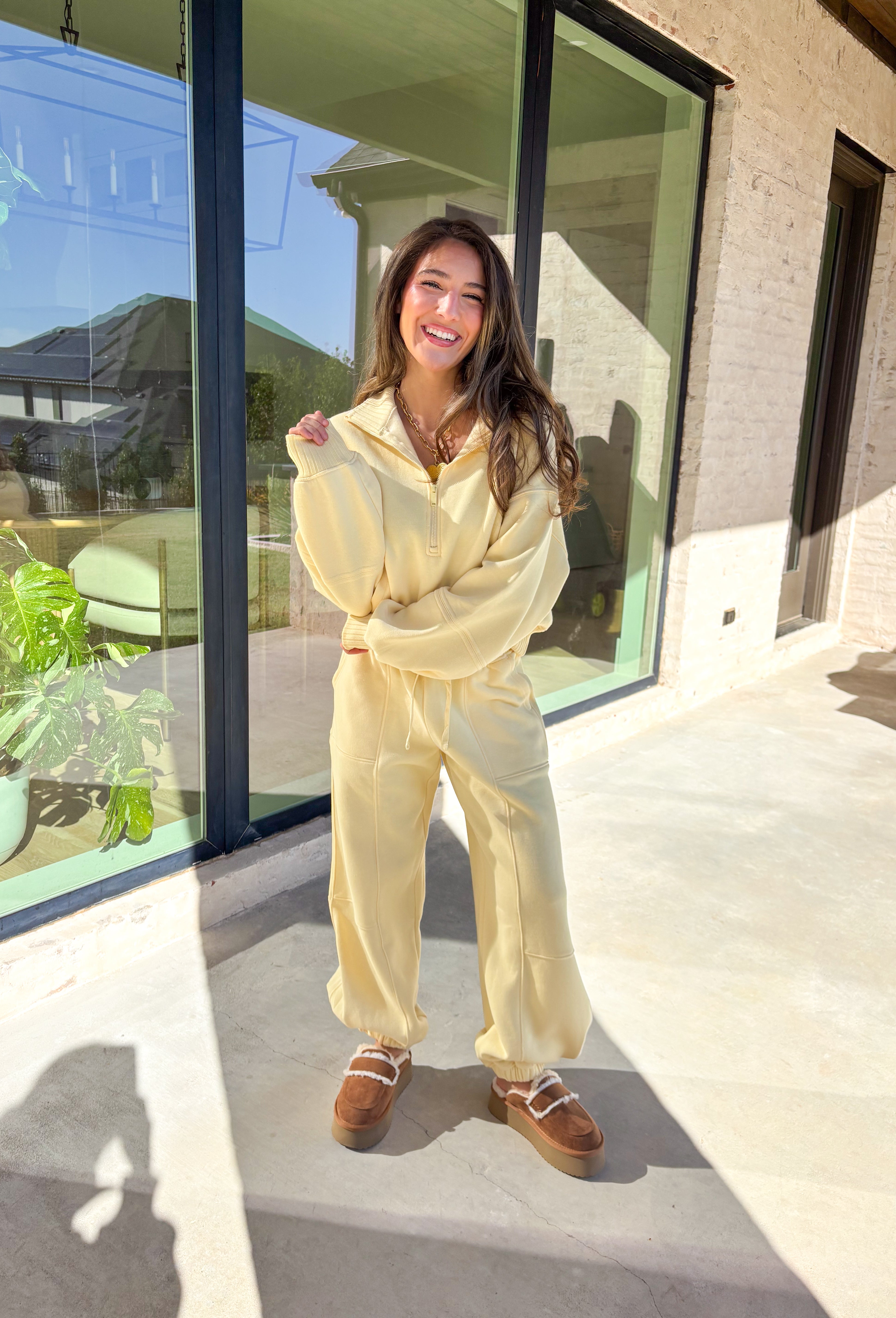 Cozy up this winter in the butter yellow fleece quarter zip pullover by Rae Mode. Designed with ribbed detailing along the collar, hem, and sleeve cuffs, this pullover combines a relaxed fit with an effortlessly polished look. The soft fleece interior and front pockets add extra warmth and comfort, making it the perfect throw-on for chilly days. Pair it with the matching joggers for the full set, or style it solo for an easy, laid-back outfit.