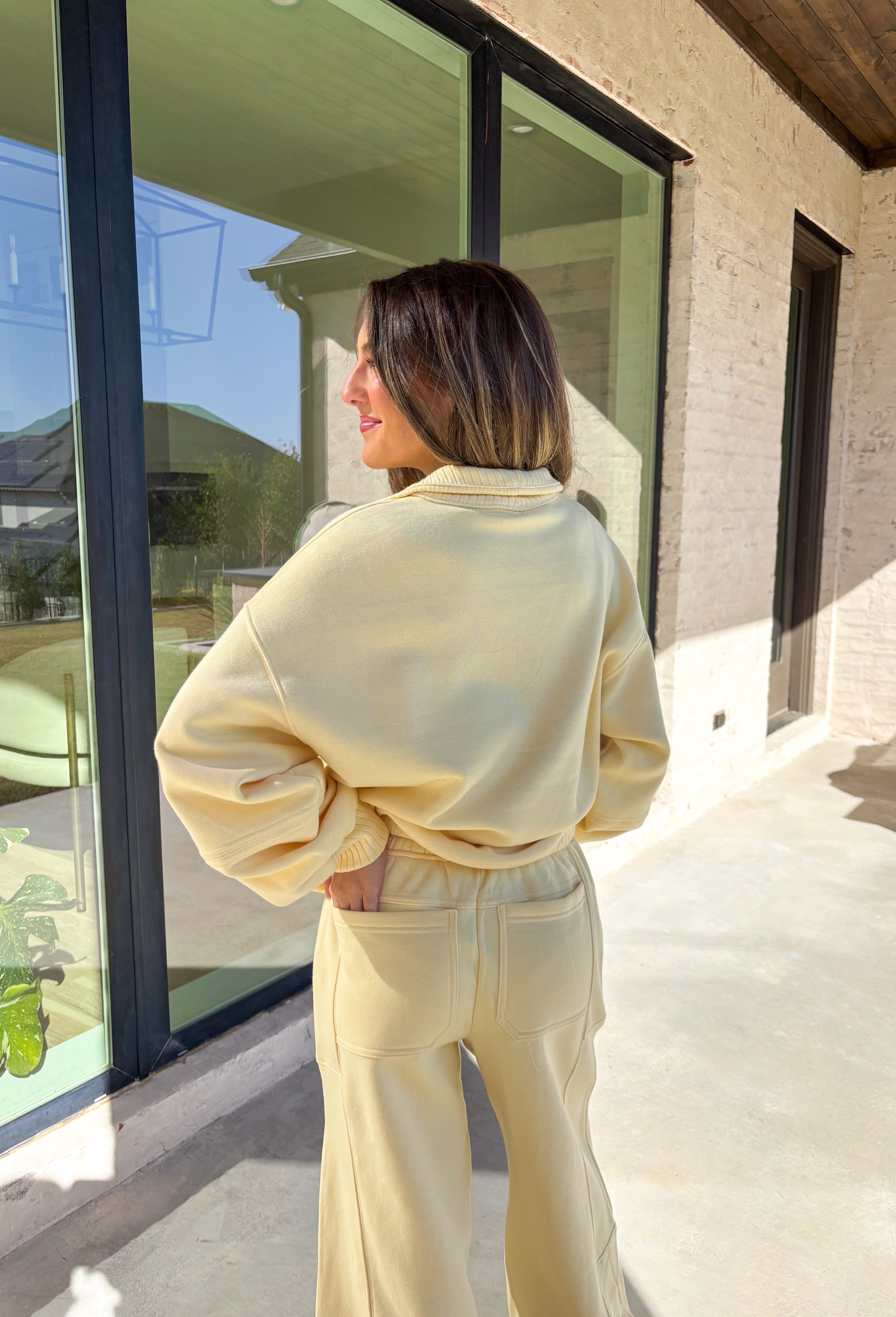 Cozy up this winter in the butter yellow fleece quarter zip pullover by Rae Mode. Designed with ribbed detailing along the collar, hem, and sleeve cuffs, this pullover combines a relaxed fit with an effortlessly polished look. The soft fleece interior and front pockets add extra warmth and comfort, making it the perfect throw-on for chilly days. Pair it with the matching joggers for the full set, or style it solo for an easy, laid-back outfit.