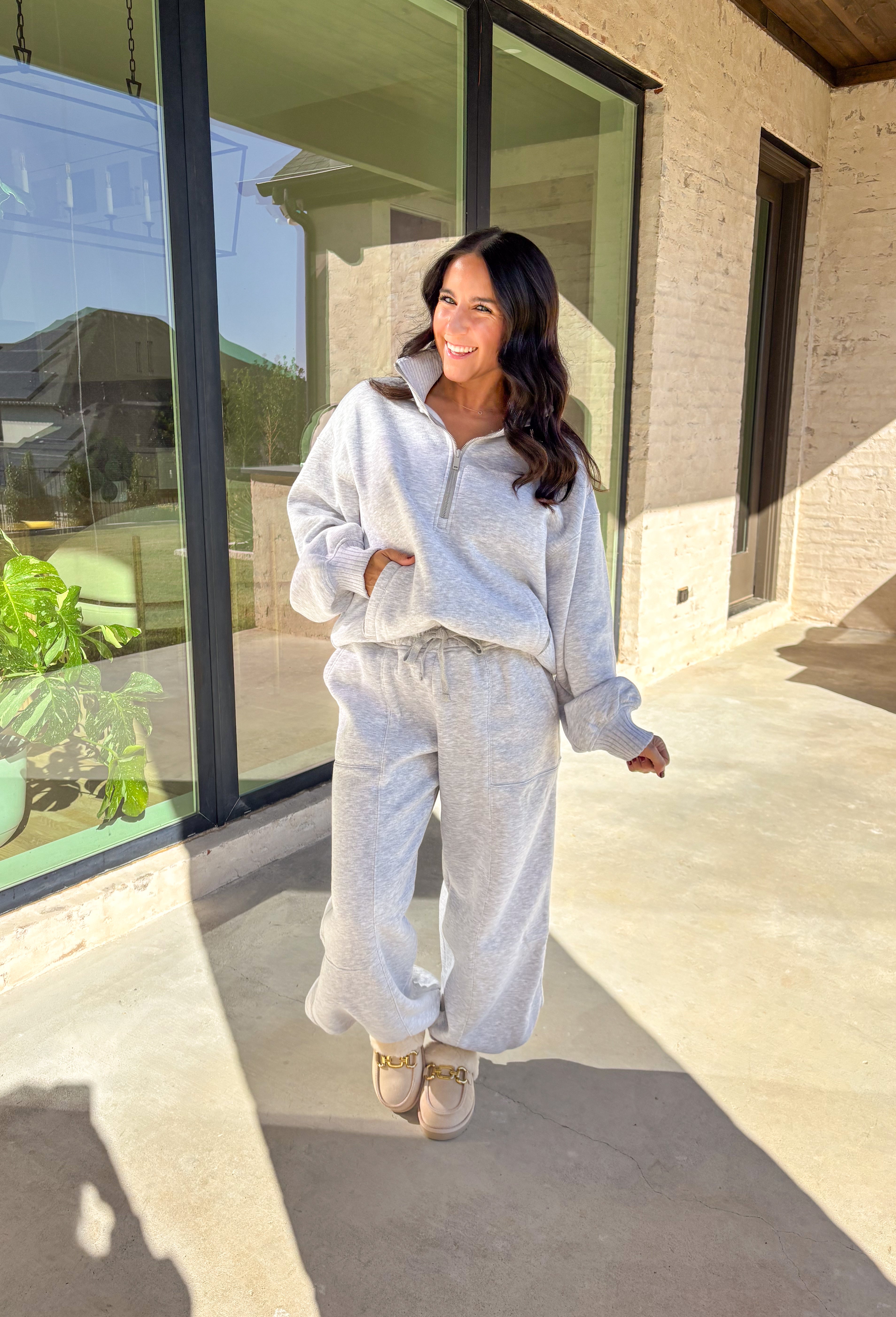 Cozy up this winter in the heather gray fleece quarter zip pullover by Rae Mode. Designed with ribbed detailing along the collar, hem, and sleeve cuffs, this pullover combines a relaxed fit with an effortlessly polished look. The soft fleece interior and front pockets add extra warmth and comfort, making it the perfect throw-on for chilly days. Pair it with the matching joggers for the full set, or style it solo for an easy, laid-back outfit.