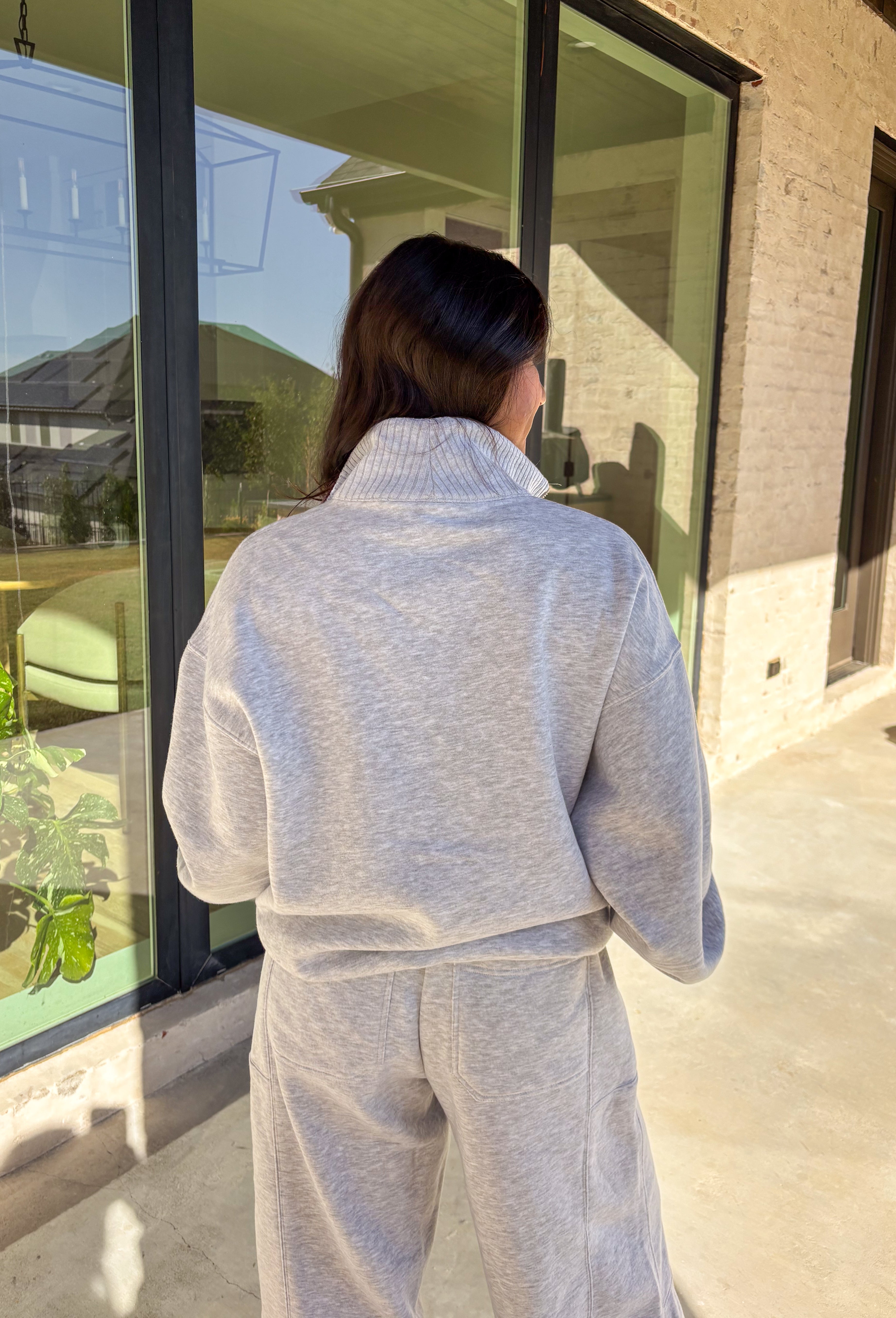 Cozy up this winter in the heather gray fleece quarter zip pullover by Rae Mode. Designed with ribbed detailing along the collar, hem, and sleeve cuffs, this pullover combines a relaxed fit with an effortlessly polished look. The soft fleece interior and front pockets add extra warmth and comfort, making it the perfect throw-on for chilly days. Pair it with the matching joggers for the full set, or style it solo for an easy, laid-back outfit.