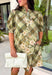 Classic plaid meets delicate florals in this charming dress from Entro. Designed with an olive plaid backdrop and a beautiful neutral floral print, this timeless piece is full of feminine details you'll love. The ruffled accent neck band collar adds an elegant touch, while the button-front closure and puff sleeves create an effortlessly polished silhouette. 