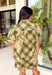 Classic plaid meets delicate florals in this charming dress from Entro. Designed with an olive plaid backdrop and a beautiful neutral floral print, this timeless piece is full of feminine details you'll love. The ruffled accent neck band collar adds an elegant touch, while the button-front closure and puff sleeves create an effortlessly polished silhouette. 