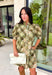 Classic plaid meets delicate florals in this charming dress from Entro. Designed with an olive plaid backdrop and a beautiful neutral floral print, this timeless piece is full of feminine details you'll love. The ruffled accent neck band collar adds an elegant touch, while the button-front closure and puff sleeves create an effortlessly polished silhouette. 