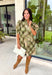 Classic plaid meets delicate florals in this charming dress from Entro. Designed with an olive plaid backdrop and a beautiful neutral floral print, this timeless piece is full of feminine details you'll love. The ruffled accent neck band collar adds an elegant touch, while the button-front closure and puff sleeves create an effortlessly polished silhouette. 