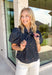 Classic fall patterns and delicate embroidery come together beautifully in this charming top. Featuring a navy and blue checkered print accented with light pink floral embroidery, this top brings a fresh, feminine touch to your autumn wardrobe. The self-tie neckline adds timeless charm, while the short puff sleeves with elastic cuffs create a flattering silhouette that's easy to wear from day to night. 