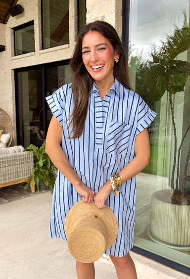 This light blue stripe dress is the kind of easy, polished piece you’ll reach for all summer long! The navy stripe print keeps it classic, while the collared v-neckline adds a slightly elevated touch that still feels effortless. With cuffed sleeves and a front pocket, it has that relaxed, everyday feel—plus side pockets (always a win). Made from breathable cotton and fully lined, it’s comfortable enough for all-day wear. From errands to lunch plans, this dress makes getting ready simple. 