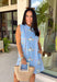 Sweet, sunny, and perfect for spring, this chambray sleeveless dress by Entro is full of charming detail. Designed with colorful floral embroidery in coral, white, navy, and green, it adds a beautiful pop against the soft chambray base. Scalloped trim along the neckline and sleeves gives it a delicate, feminine finish, while the button closure at the back adds a subtle touch of interest. Fully lined and complete with side pockets.