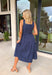 Timeless, feminine, and effortlessly polished! This navy midi dress features a classic white polka dot print that never goes out of style. The square neckline creates a flattering, structured silhouette, while the sleeveless design keeps it light and perfect for warm days. Smocking along the back bodice provides comfortable stretch and a beautiful fit, while the back zipper closure keeps the look clean and tailored. Finished with side pockets and breathable cotton fabric.