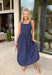 Timeless, feminine, and effortlessly polished! This navy midi dress features a classic white polka dot print that never goes out of style. The square neckline creates a flattering, structured silhouette, while the sleeveless design keeps it light and perfect for warm days. Smocking along the back bodice provides comfortable stretch and a beautiful fit, while the back zipper closure keeps the look clean and tailored. Finished with side pockets and breathable cotton fabric.