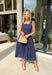 Timeless, feminine, and effortlessly polished! This navy midi dress features a classic white polka dot print that never goes out of style. The square neckline creates a flattering, structured silhouette, while the sleeveless design keeps it light and perfect for warm days. Smocking along the back bodice provides comfortable stretch and a beautiful fit, while the back zipper closure keeps the look clean and tailored. Finished with side pockets and breathable cotton fabric.