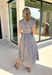 Rich autumn hues and timeless details make this striped midi dress an easy favorite for the season ahead. Featuring light blue and brown stripes, this dress captures everything we love about fall. The flattering v-neckline is finished with a sweet self-tie detail, while the gathered waist creates a feminine silhouette that's both comfortable and flattering. Cap sleeves, side pockets, and a fully lined design make it as practical as it is stylish. 