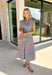 Rich autumn hues and timeless details make this striped midi dress an easy favorite for the season ahead. Featuring light blue and brown stripes, this dress captures everything we love about fall. The flattering v-neckline is finished with a sweet self-tie detail, while the gathered waist creates a feminine silhouette that's both comfortable and flattering. Cap sleeves, side pockets, and a fully lined design make it as practical as it is stylish. 