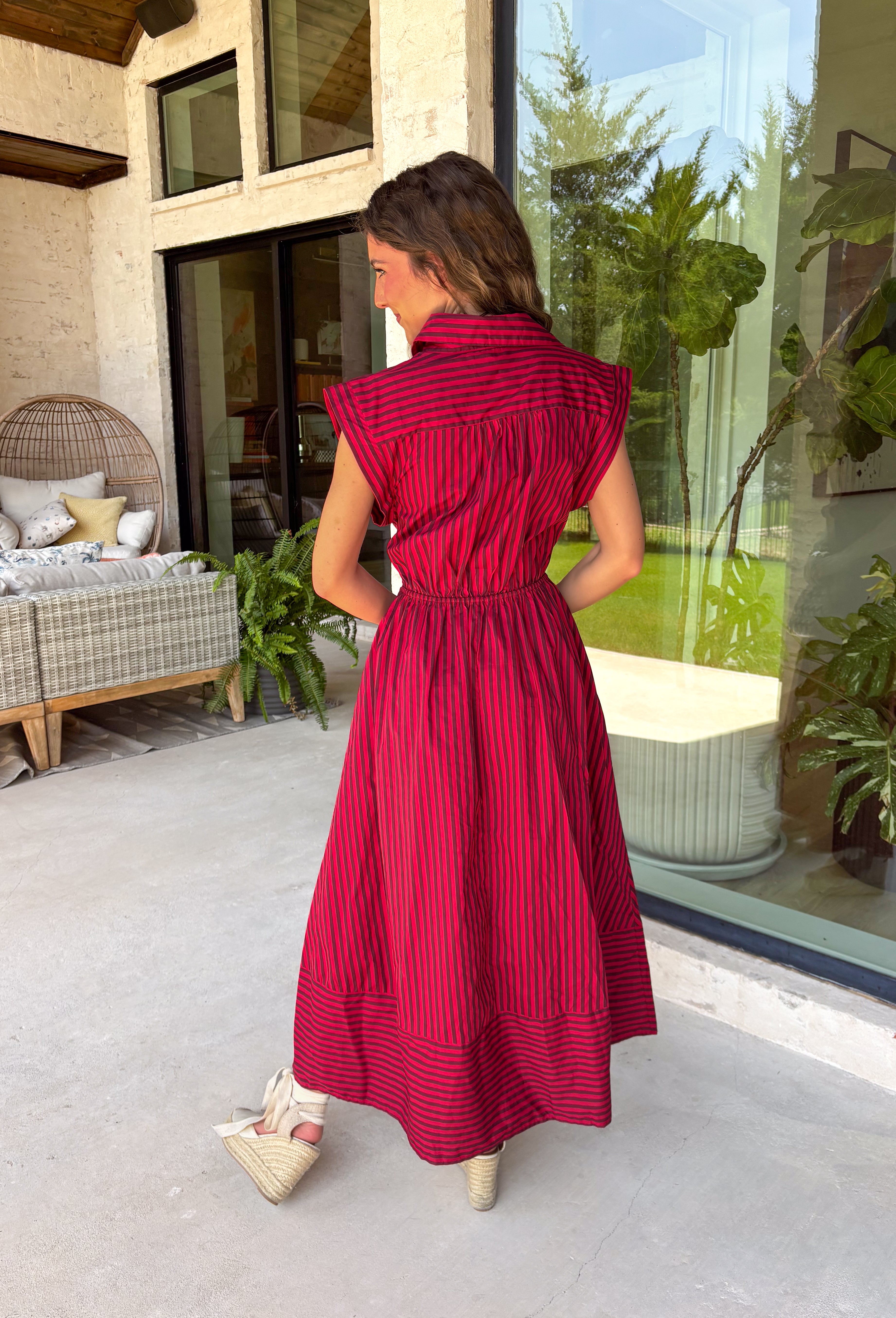 Rich autumn hues and timeless details make this striped midi dress an easy favorite for the season ahead. Featuring warm red and brown stripes, this dress captures everything we love about fall. The flattering v-neckline is finished with a sweet self-tie detail, while the gathered waist creates a feminine silhouette that's both comfortable and flattering. Cap sleeves, side pockets, and a fully lined design make it as practical as it is stylish. 