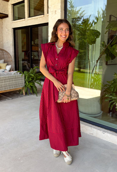 Rich autumn hues and timeless details make this striped midi dress an easy favorite for the season ahead. Featuring warm red and brown stripes, this dress captures everything we love about fall. The flattering v-neckline is finished with a sweet self-tie detail, while the gathered waist creates a feminine silhouette that's both comfortable and flattering. Cap sleeves, side pockets, and a fully lined design make it as practical as it is stylish. 