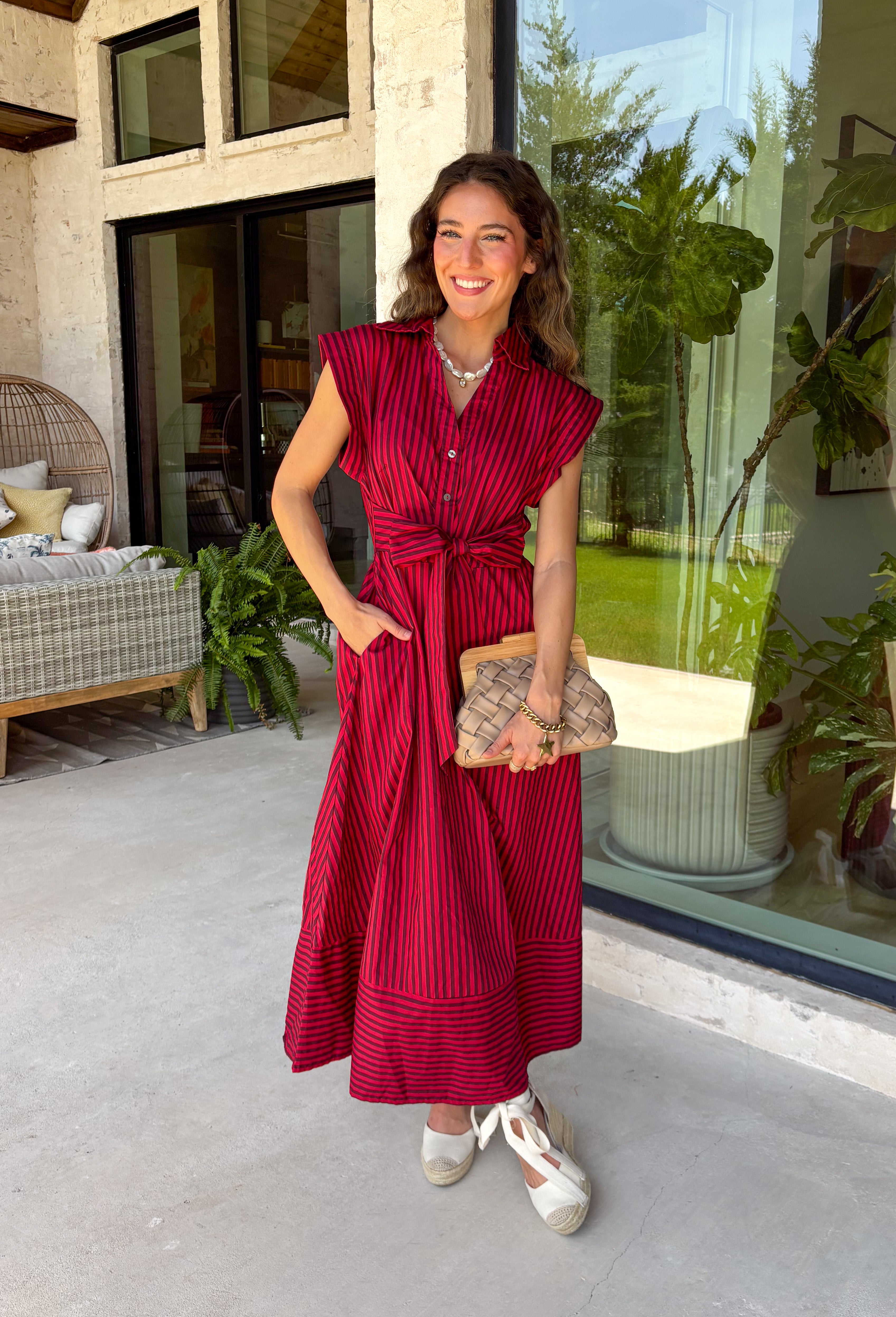 Rich autumn hues and timeless details make this striped midi dress an easy favorite for the season ahead. Featuring warm red and brown stripes, this dress captures everything we love about fall. The flattering v-neckline is finished with a sweet self-tie detail, while the gathered waist creates a feminine silhouette that's both comfortable and flattering. Cap sleeves, side pockets, and a fully lined design make it as practical as it is stylish. 