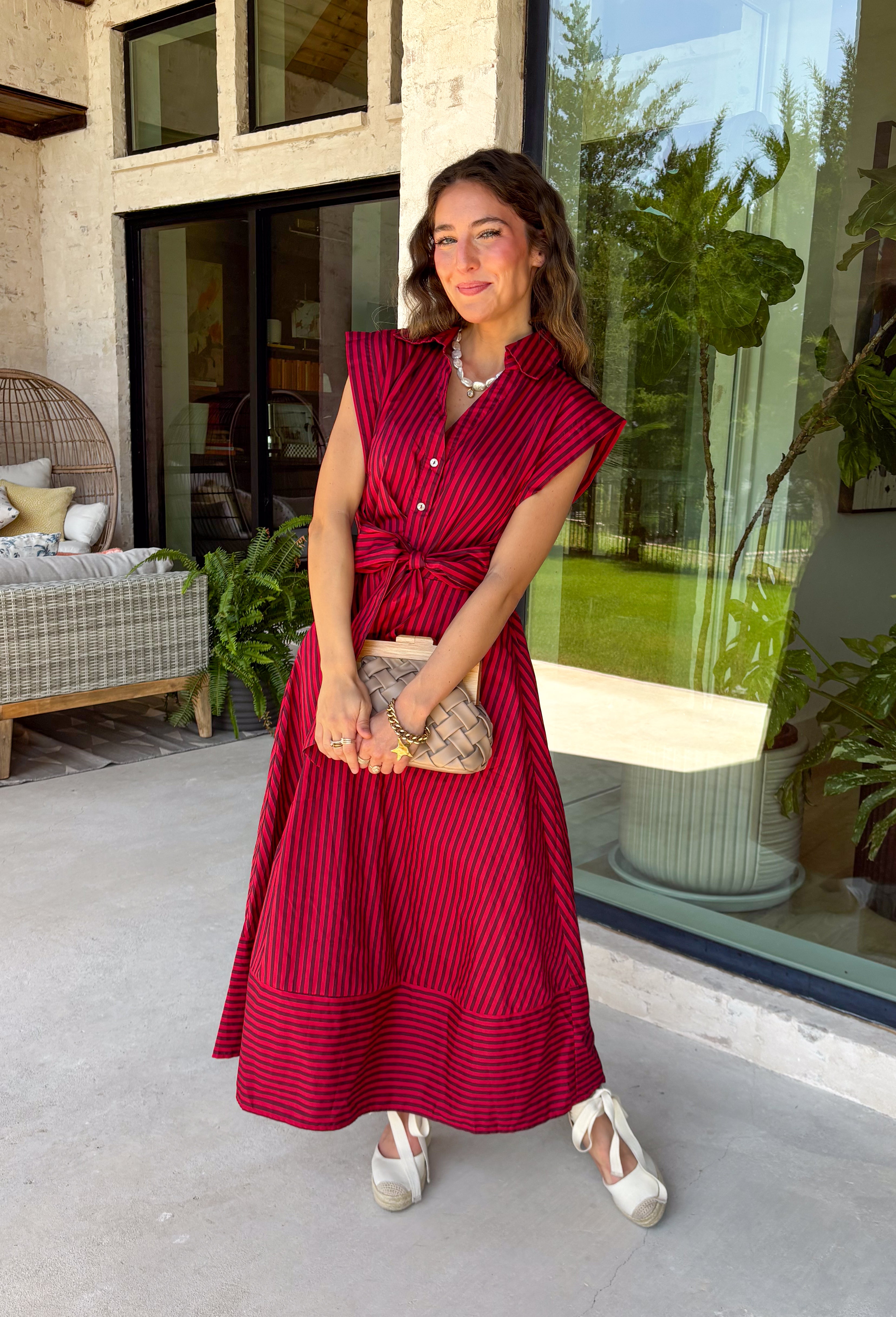 Rich autumn hues and timeless details make this striped midi dress an easy favorite for the season ahead. Featuring warm red and brown stripes, this dress captures everything we love about fall. The flattering v-neckline is finished with a sweet self-tie detail, while the gathered waist creates a feminine silhouette that's both comfortable and flattering. Cap sleeves, side pockets, and a fully lined design make it as practical as it is stylish. 
