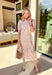 Say hello to your new go-to spring dress! This off white botanical midi dress by Entro is sprinkled with the prettiest floral pops of pink, yellow, and green for the ultimate fresh-picked feel. The ruffled band collar and v-neckline add a sweet, feminine touch, while the button-front design and side pockets keep it practical (because cute AND functional is the goal). Fully lined and easy to wear from brunch to special occasions to weekend plans!