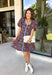 Bring timeless elegance to your fall wardrobe with this beautifully detailed dress from Entro. Designed with a rich brown backdrop and a stunning blue floral print, this feminine dress is full of eye-catching seasonal charm. The flattering square neckline is accented with beautiful blue contrast trim, while the pleated waist creates a flattering, defined silhouette. 