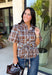 Classic plaid gets a fresh fall update with this brown and blue blouse from Entro. The mix of warm brown and cool blue creates an eye-catching color combination that fits right into your autumn wardrobe. A shirt collar and button-front closure give it a classic feel, while pleated detailing at the front and back adds shape and texture. The self-tie belt lets you define the waist, and the peplum hem creates a flattering finish that's perfect with denim or trousers. 
