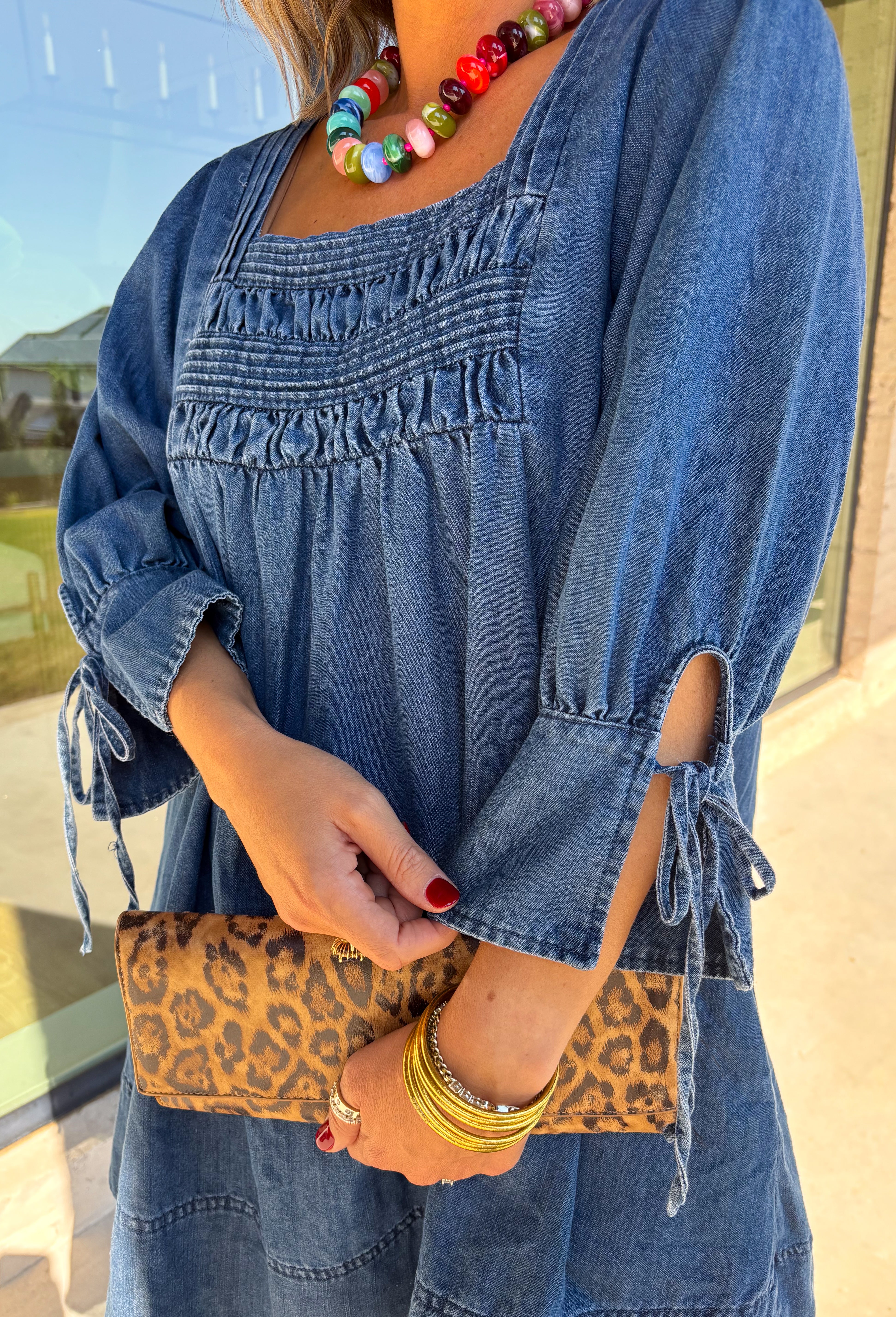 A timeless denim dress is always in style, and this one is made for all your favorite fall moments! Crafted from soft dark wash denim, this effortlessly feminine dress features a flattering smocked yoke that adds beautiful texture and a comfortable fit. The square neckline gives it a modern, polished look, while the tie details on the sleeves add the sweetest finishing touch. 