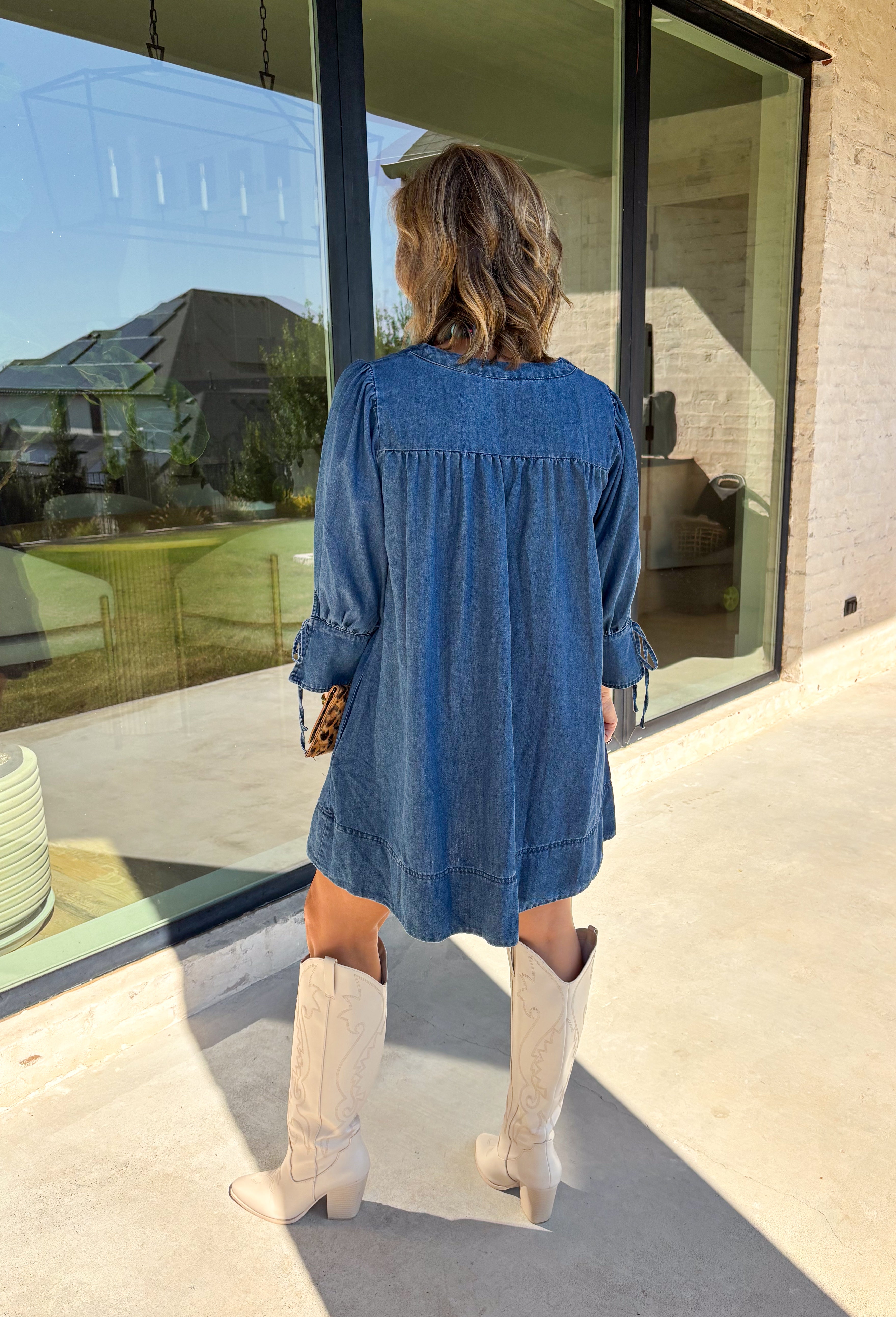 A timeless denim dress is always in style, and this one is made for all your favorite fall moments! Crafted from soft dark wash denim, this effortlessly feminine dress features a flattering smocked yoke that adds beautiful texture and a comfortable fit. The square neckline gives it a modern, polished look, while the tie details on the sleeves add the sweetest finishing touch. 