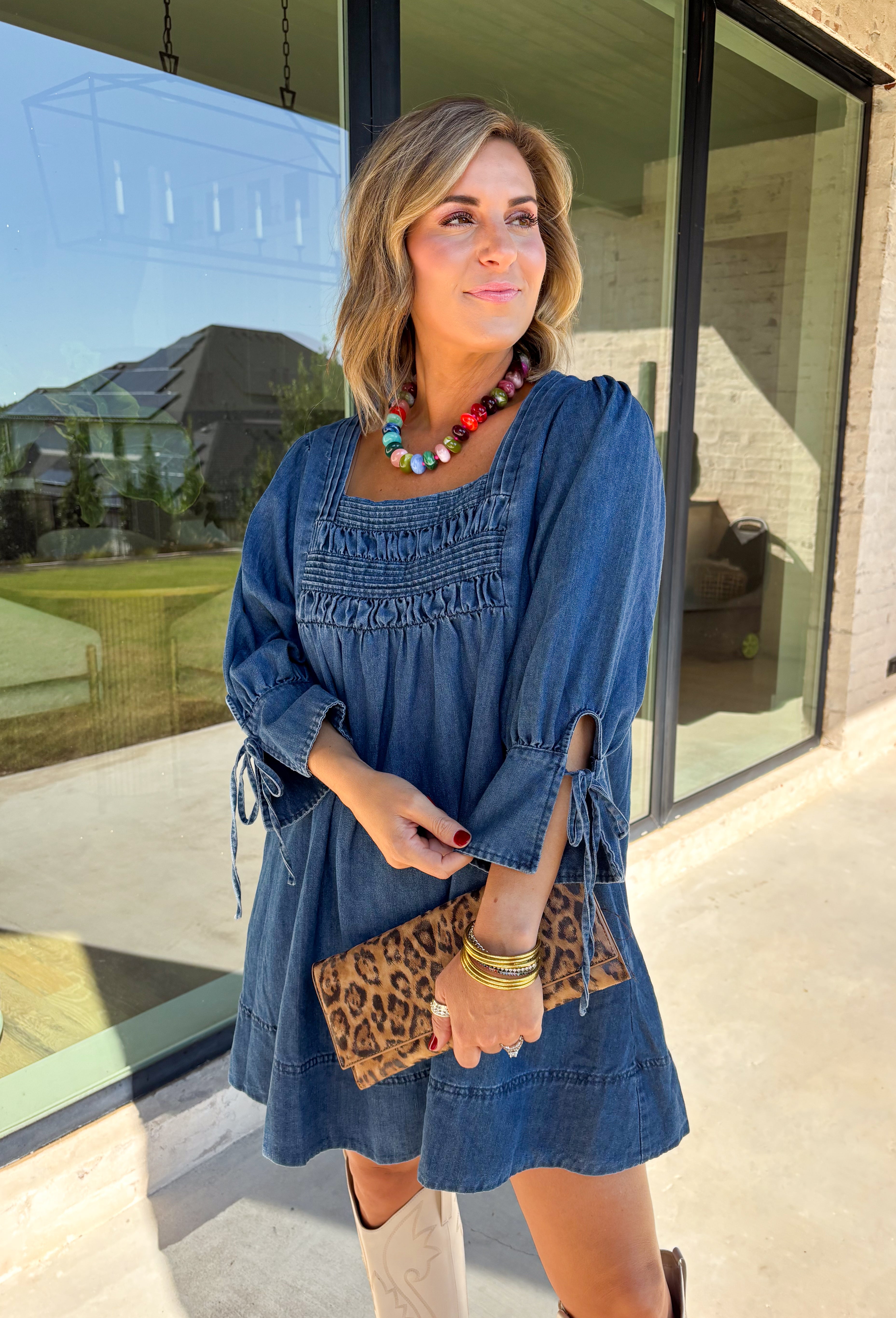 A timeless denim dress is always in style, and this one is made for all your favorite fall moments! Crafted from soft dark wash denim, this effortlessly feminine dress features a flattering smocked yoke that adds beautiful texture and a comfortable fit. The square neckline gives it a modern, polished look, while the tie details on the sleeves add the sweetest finishing touch. 