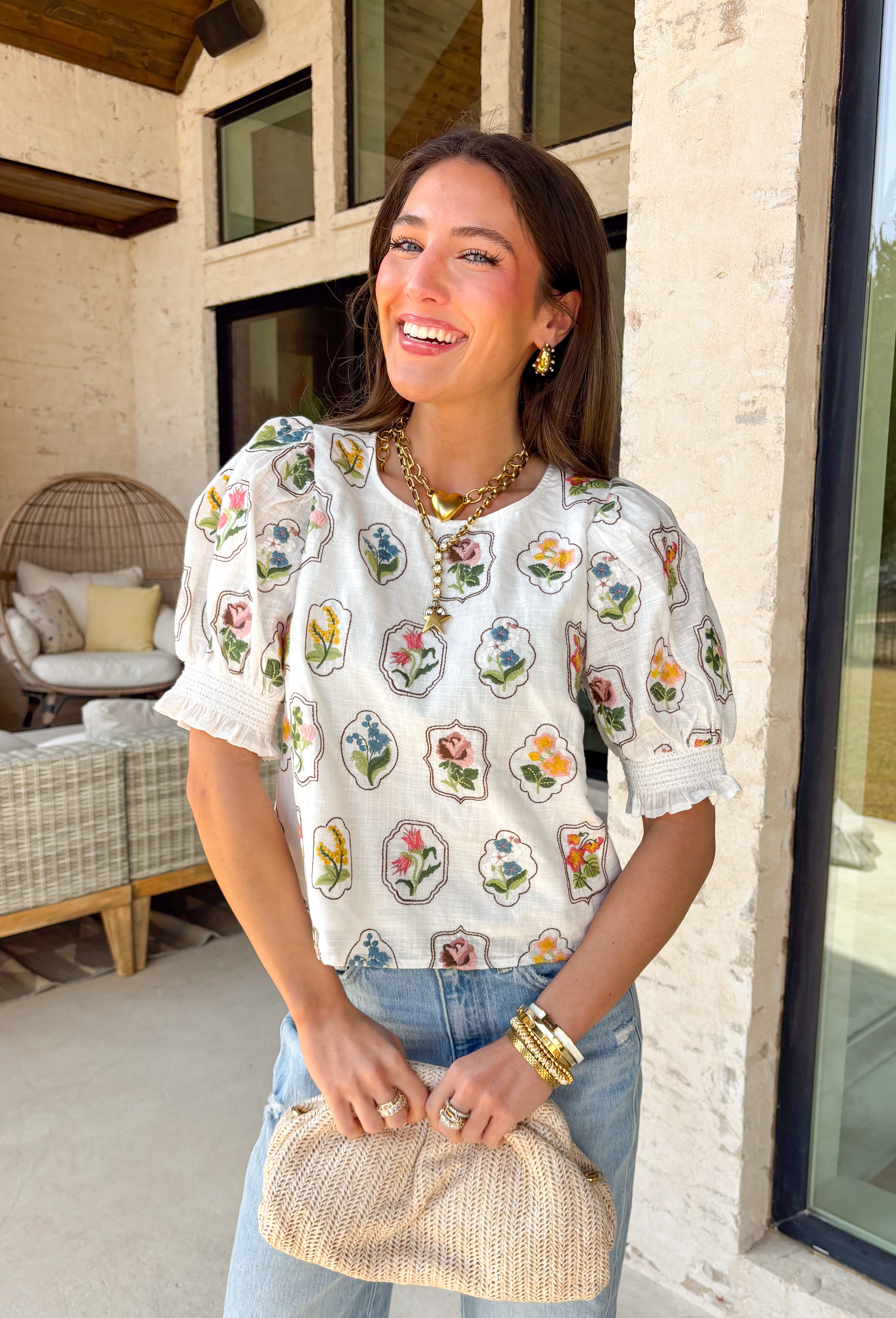 If you love a top that feels sweet, unique, and totally spring-ready, this off white top by Entro is going to be your new favorite. The patchwork-style floral embroidery along the front and sleeves is packed with beautiful color—brown, pink, green, yellow, and blue—giving it that one-of-a-kind look that instantly upgrades even your simplest denim. 
