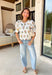 If you love a top that feels sweet, unique, and totally spring-ready, this off white top by Entro is going to be your new favorite. The patchwork-style floral embroidery along the front and sleeves is packed with beautiful color—brown, pink, green, yellow, and blue—giving it that one-of-a-kind look that instantly upgrades even your simplest denim. 