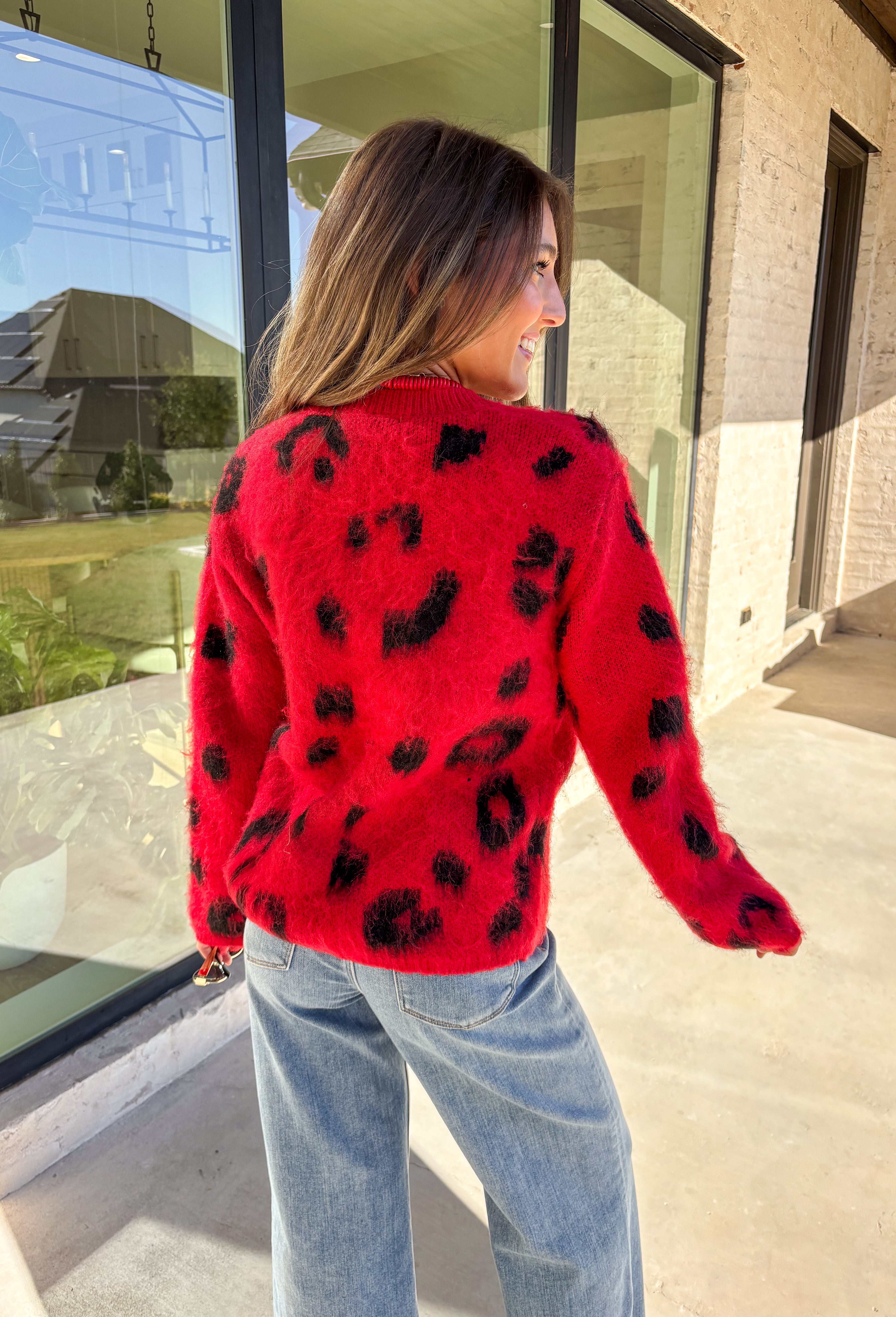 Make a bold statement while staying cozy in this red fuzzy button-down cardigan by See and Be Seen. Featuring a playful black leopard print, this cardigan adds a fun twist to chilly-day layering. The ultra-soft texture feels as good as it looks, making it a go-to for everything from lounging at home to dressing up your favorite denim.
