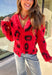 Make a bold statement while staying cozy in this red fuzzy button-down cardigan by See and Be Seen. Featuring a playful black leopard print, this cardigan adds a fun twist to chilly-day layering. The ultra-soft texture feels as good as it looks, making it a go-to for everything from lounging at home to dressing up your favorite denim.