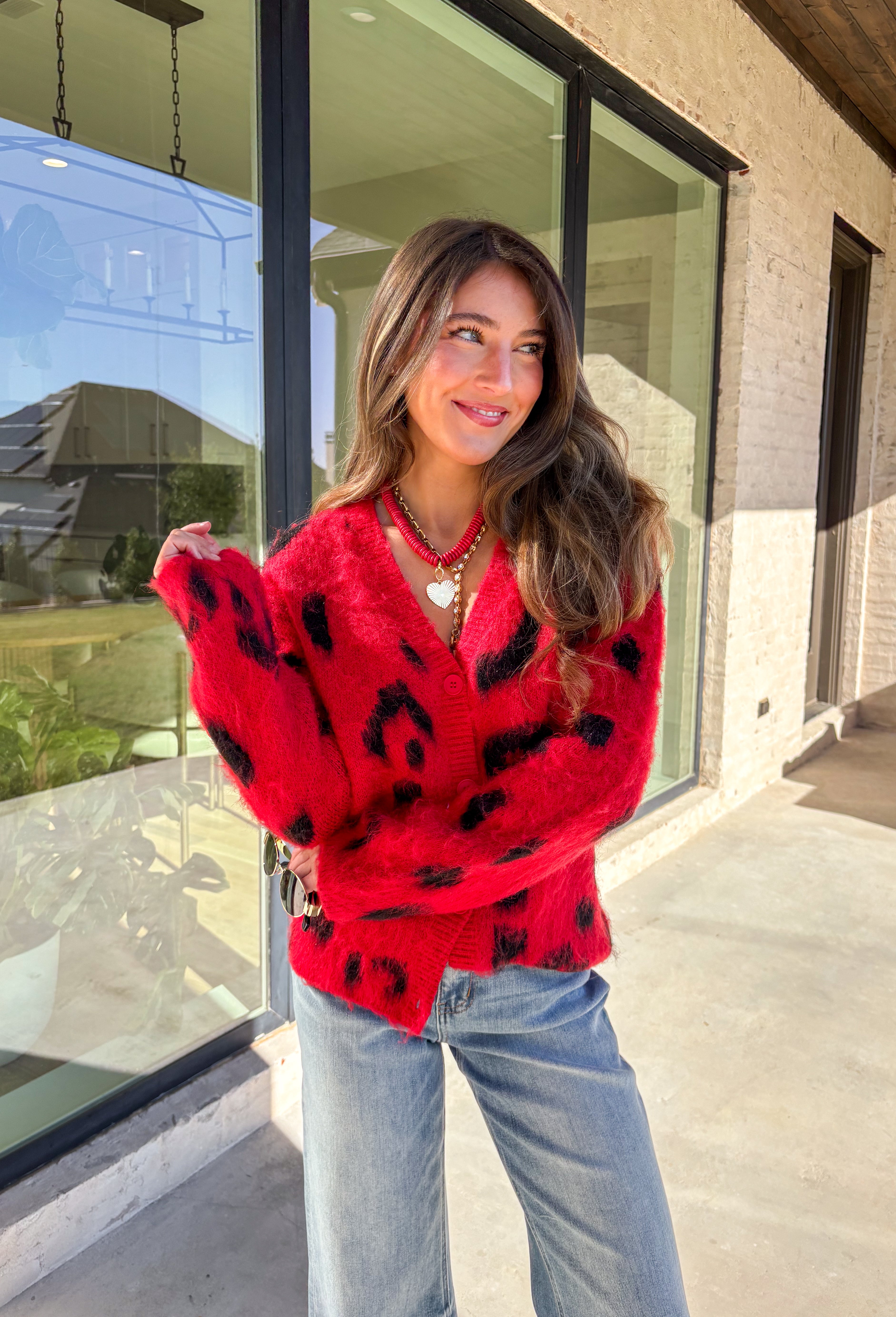Make a bold statement while staying cozy in this red fuzzy button-down cardigan by See and Be Seen. Featuring a playful black leopard print, this cardigan adds a fun twist to chilly-day layering. The ultra-soft texture feels as good as it looks, making it a go-to for everything from lounging at home to dressing up your favorite denim.