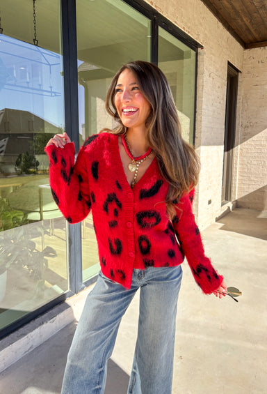 Make a bold statement while staying cozy in this red fuzzy button-down cardigan by See and Be Seen. Featuring a playful black leopard print, this cardigan adds a fun twist to chilly-day layering. The ultra-soft texture feels as good as it looks, making it a go-to for everything from lounging at home to dressing up your favorite denim.
