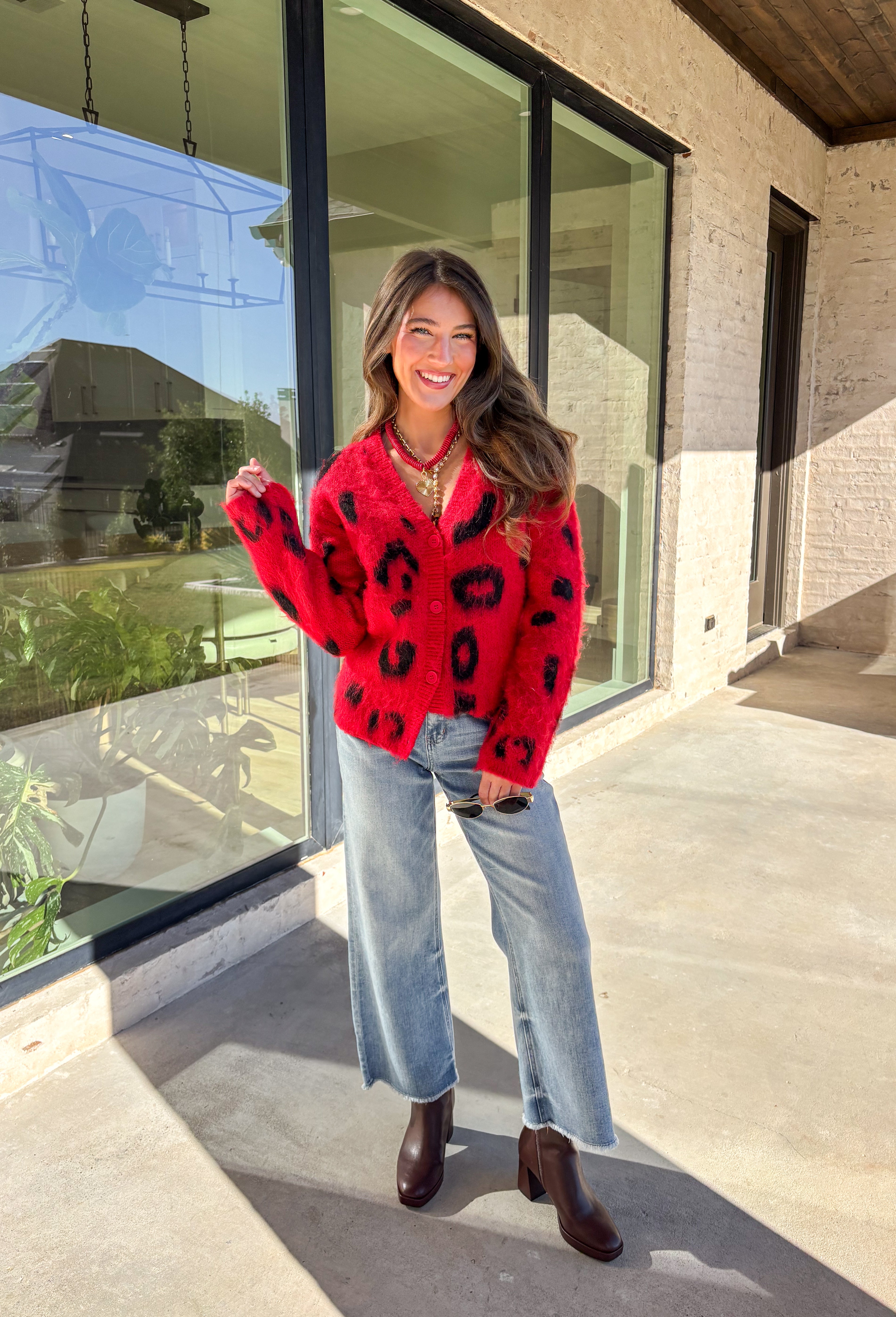 Make a bold statement while staying cozy in this red fuzzy button-down cardigan by See and Be Seen. Featuring a playful black leopard print, this cardigan adds a fun twist to chilly-day layering. The ultra-soft texture feels as good as it looks, making it a go-to for everything from lounging at home to dressing up your favorite denim.