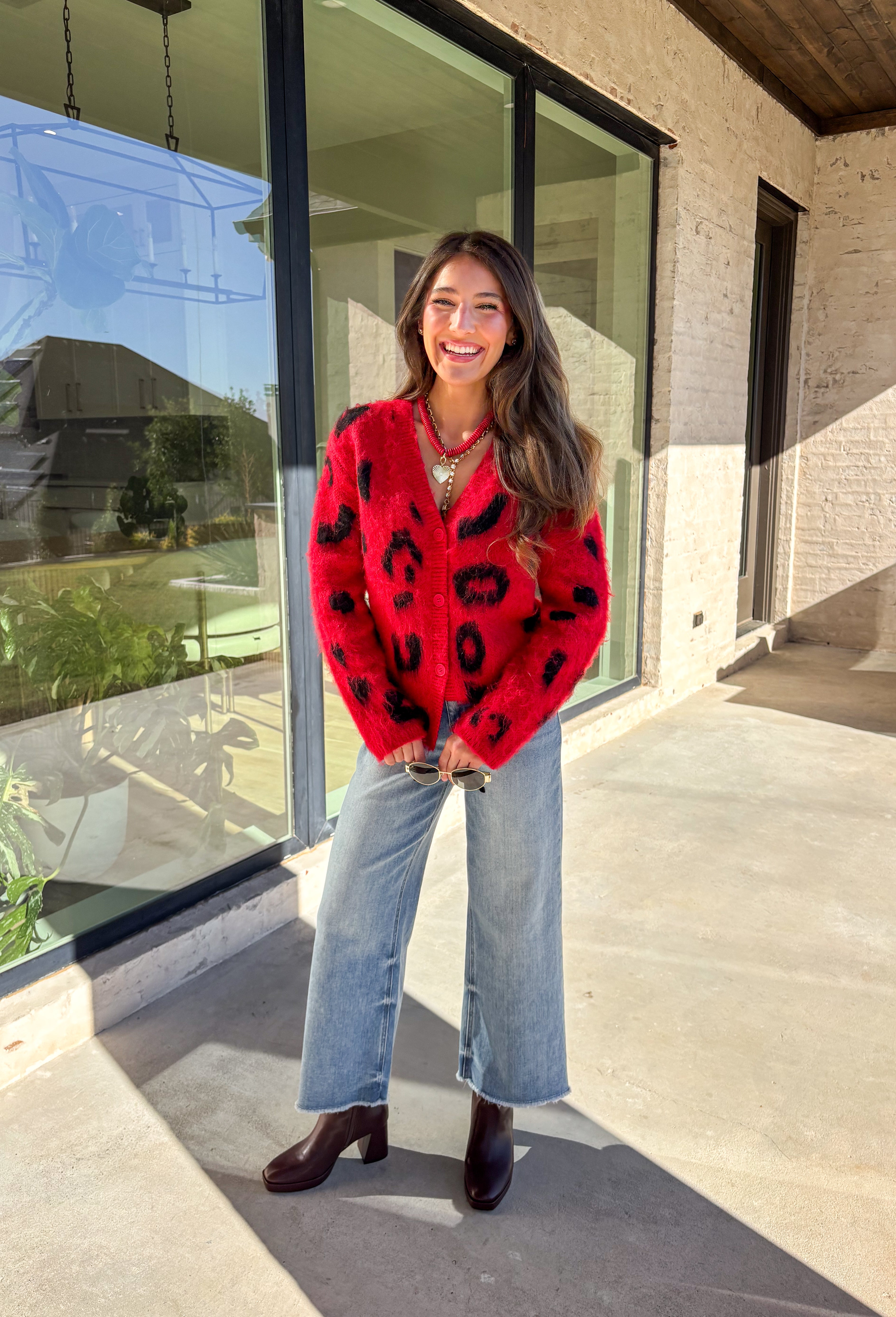 Make a bold statement while staying cozy in this red fuzzy button-down cardigan by See and Be Seen. Featuring a playful black leopard print, this cardigan adds a fun twist to chilly-day layering. The ultra-soft texture feels as good as it looks, making it a go-to for everything from lounging at home to dressing up your favorite denim.