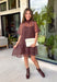 Classic polka dots get a fresh seasonal update in this charming dress from Entro. Designed with a rich brown backdrop and playful blue polka dots, this effortlessly feminine dress is perfect for everything from brunch dates to weekend outings. The high neckline creates a polished silhouette, while the back tie detail adds a sweet finishing touch. A flirty ruffle hem brings beautiful movement, and the fully lined lightweight fabric keeps you comfortable all day long.