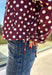 Give your fall layers a playful update with this wine-colored polka dot jacket from Entro. The rich wine shade is covered in classic white polka dots, creating a fun statement print that still pairs easily with your favorite seasonal neutrals. A collared neckline and button-down front give it a classic jacket feel, while tie details at the front and sides of the hem add a unique finishing touch. 