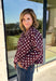 Give your fall layers a playful update with this wine-colored polka dot jacket from Entro. The rich wine shade is covered in classic white polka dots, creating a fun statement print that still pairs easily with your favorite seasonal neutrals. A collared neckline and button-down front give it a classic jacket feel, while tie details at the front and sides of the hem add a unique finishing touch. 