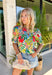 Bright, cheerful, and ready for all your spring plans, this off-white floral top by Entro is the kind of piece that instantly lifts your whole outfit. The colorful print features pops of green, red, pink, and blue for the prettiest burst of seasonal color, while the ruffled mock neck and v-neckline add a flattering, feminine touch. Finished with puff sleeves and elasticated cuffs, it’s easy to wear, easy to love, and perfect for everything from brunch to the office.