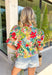 Bright, cheerful, and ready for all your spring plans, this off-white floral top by Entro is the kind of piece that instantly lifts your whole outfit. The colorful print features pops of green, red, pink, and blue for the prettiest burst of seasonal color, while the ruffled mock neck and v-neckline add a flattering, feminine touch. Finished with puff sleeves and elasticated cuffs, it’s easy to wear, easy to love, and perfect for everything from brunch to the office.