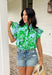 Soft, fresh, and full of spring charm! This light blue short sleeve top features a beautiful green floral print layered over textured floral eyelet lace for the prettiest dimension. It’s feminine without feeling fussy — just the right balance of sweet and polished. Designed with a classic button down front, this top is finished with a ruffle neckline and ruffle sleeves that add movement and a soft romantic touch. Crafted from breathable 100% cotton.