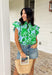 Soft, fresh, and full of spring charm! This light blue short sleeve top features a beautiful green floral print layered over textured floral eyelet lace for the prettiest dimension. It’s feminine without feeling fussy — just the right balance of sweet and polished. Designed with a classic button down front, this top is finished with a ruffle neckline and ruffle sleeves that add movement and a soft romantic touch. Crafted from breathable 100% cotton.