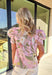Sweet, soft, and ready for sunshine, this light pink floral top by Umgee is a spring staple you’ll reach for again and again. Featuring a delicate floral print in shades of green, pink, cream, and tan, this top feels fresh and feminine without trying too hard. The puff sleeves add just the right amount of volume, while the scalloped trim along the front gives it a charming, elevated finish that’s perfect for everyday wear.