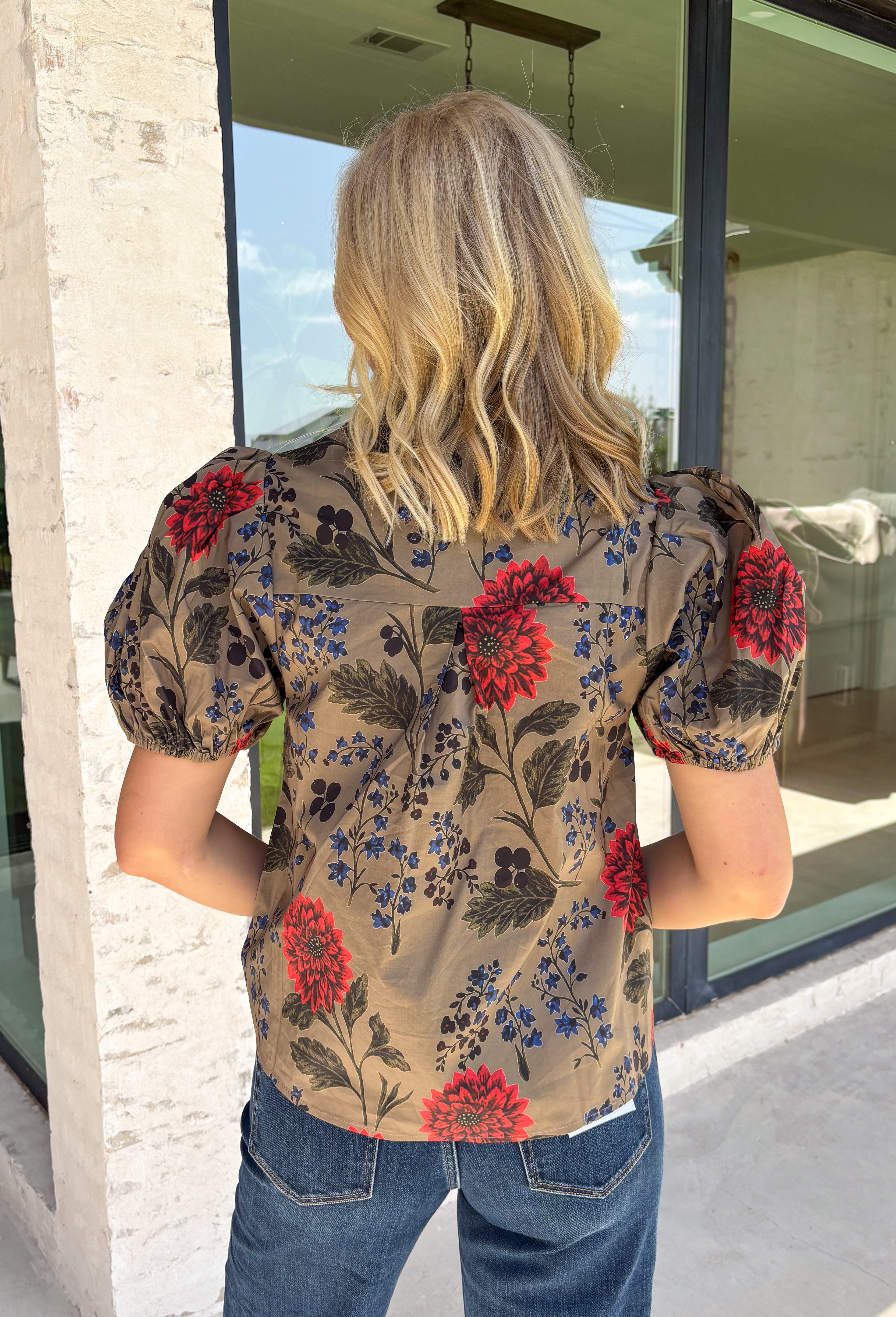 Bring warm autumn colors to your everyday wardrobe with this effortlessly feminine floral blouse. Designed with a beautiful camel backdrop and a vibrant floral print in shades of red, black, olive, and navy, this timeless top is perfect for everything from workdays to weekend outings. Delicate pleating along the front adds beautiful texture, while the button-front design and elastic cuff sleeves create a polished yet comfortable look. 