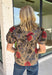 Bring warm autumn colors to your everyday wardrobe with this effortlessly feminine floral blouse. Designed with a beautiful camel backdrop and a vibrant floral print in shades of red, black, olive, and navy, this timeless top is perfect for everything from workdays to weekend outings. Delicate pleating along the front adds beautiful texture, while the button-front design and elastic cuff sleeves create a polished yet comfortable look. 