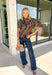 Bring warm autumn colors to your everyday wardrobe with this effortlessly feminine floral blouse. Designed with a beautiful camel backdrop and a vibrant floral print in shades of red, black, olive, and navy, this timeless top is perfect for everything from workdays to weekend outings. Delicate pleating along the front adds beautiful texture, while the button-front design and elastic cuff sleeves create a polished yet comfortable look. 